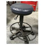 Rolling stool, adjustable height.