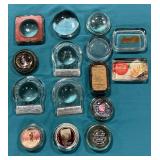 Assortment of advertising glass paperweight