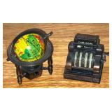 Pair of pencil sharpeners, cash register  & world globe