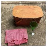 Woven picnic basket with picnic supplies