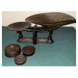Antique cast iron balance scale with weights