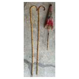 Pair of bamboo canes and umbrella (some damage)