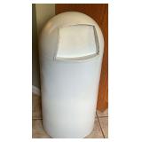 Metal trash can with a dent