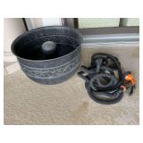 Metal garden hose basket with hose