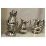 Silverplate pitchers, one with damage