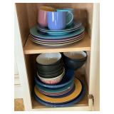 Colorful dishware, some with chips