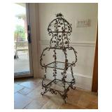 Ornate metal and glass shelf estagere features a decorative, cage-like domed top with vine and leaf details , 52" T