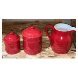 Red water pitcher and pair of red canisters