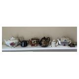 Assorted teapots, musical teapot, tea strainers, etc.