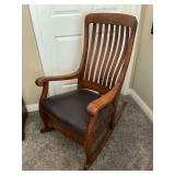 Antique rocker with leather seat.
