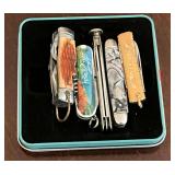 Assortment of mini pocket knives.