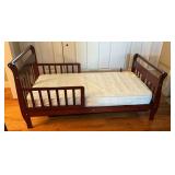 Toddler bed with Sealy mattress.