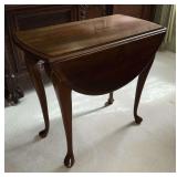 Queen Anne style drop leaf end table, top spins to hold up the leaves