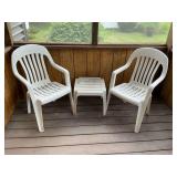 Pair of plastic patio chairs with table