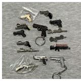 Assorted rifle and pistol hat pins, keychains