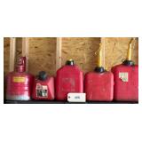 Four Plastic Fuel Cans   One Metal Fuel Can