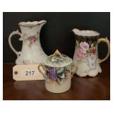 Lot of Three Hand-Painted Porcelain Pitchers and Lidded Jar with Floral and Grape Motifs