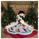 Holiday Themed Display Set Featuring Artificial Trees Snowman Figure and Quilted Tree Skirt