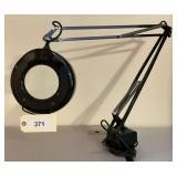 Black Adjustable Arm Magnifying Lamp with Circular Lens and Table Mount