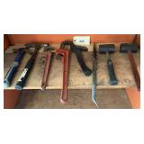 Assorted Hand Tools Including Hammers, Pipe Wrenches, and Pry Bar