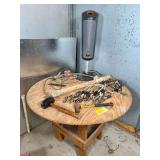 Round Wooden Table with Assorted Tools and Items