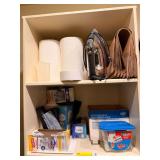 Household Utilities and Cleaning Supplies Lot Including Iron, Paper Products, and Trash Bags