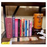 Assorted Catholic Literature Collection with Decorative Candle, Ceramic Horse Figurine, and Multi-Stone Marble Paperweight