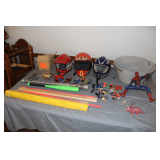 Yard Sticks, Plastic Basket with Handles, Spider-Man Figurine, (3) Bike Helmets, (2) Bats, Spider-Man Coin Bank, Watches, Hot Wheels and Misc. Brand Toy Cars, Happy Meal Toys, and Misc.