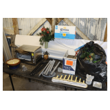 (2) Wind Chimes, Stone Bowls, Hamilton Beach Toaster Oven, Artificial Flowers, Metal Ashtrays, Electric Window Candolier, Cast Iron Dog, and Misc.