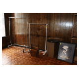 (2) Rolling Clothes Stands, Antique Square Bucket, Cardboard and Plastic Table, and Framed Cognac Print