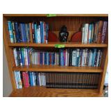 Three shelves of books includes religious and World Book encyclopedias