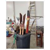 Garbage can and long handled yard tools