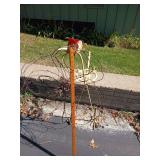 Barb wire flower and a bird made of yard stuff