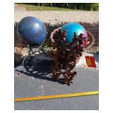 Two gazing balls, cast iron stand and a cast iron wall hanger