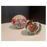 Two upright glass paperweights