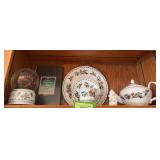 A cup of Christmas tea book, tea set and snow globe