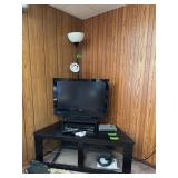 Large flat-screen tv stand w/ glass shelf, 31" Vizio HDTV, blue ray player and black floor lamp