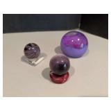 Two “marbles” w stands and purple glass paperweight