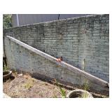 Approx 13’ long wooden water pipe and cast iron wheel center