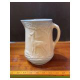Blue and white stoneware pitcher w deer design