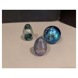 Three glass paperweights-one of the egg ones is marked Kerry Glass