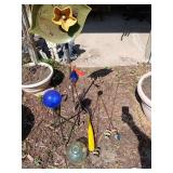 Yard decor includes small gazing ball w stand, plate flower, rocks on stakes, etc