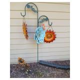 Shepherds hook w metal hanging flowers and a ground sunflower