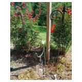 Two shepherds hooks, hanging squirrel bird feeder and a flamingo