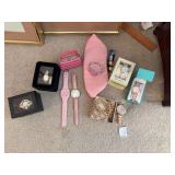 Women’s watches including Kenneth Cole, Figaro Couture, a strand of pearls and a pink clutch