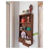 Wall shelf w things to dust