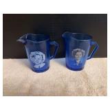 Two Shirley Temple pitchers, different designs