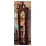 Howard Miller Cherish battery operated floor clock, lighted with mirrored back and glass shelves Model 610-614 9.5D x 17L x 76H NO CONTENTS
