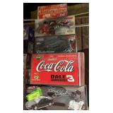 Three1:24 scale, one 1:18 and one 1:32 die cast cars as shown