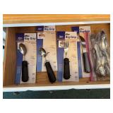 Four new Norco big-grip bendable weighted utensils and ziploc bag of other flatware